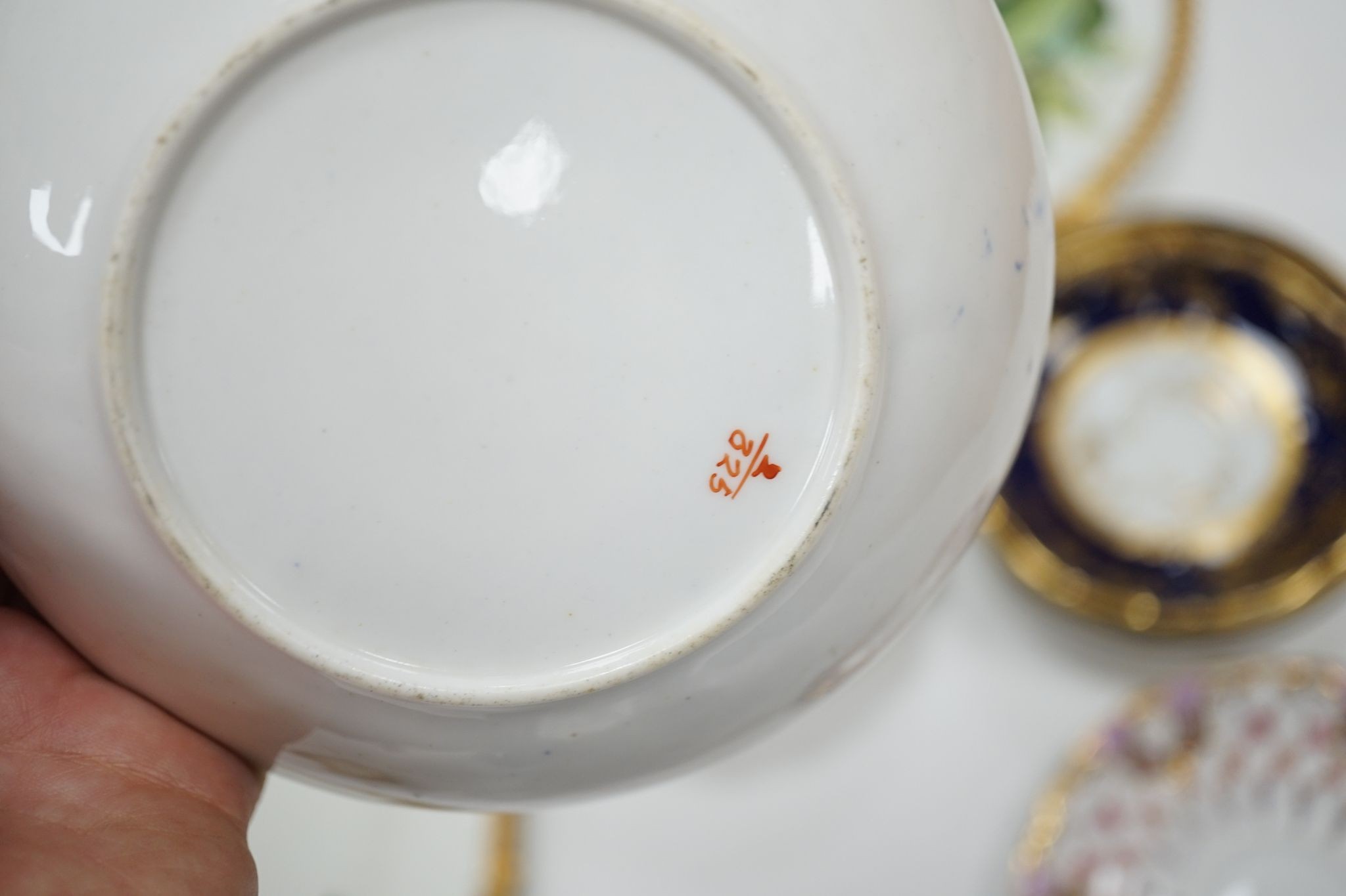 A small collection of Victorian porcelain tea cups and saucers and sundry dessert plates